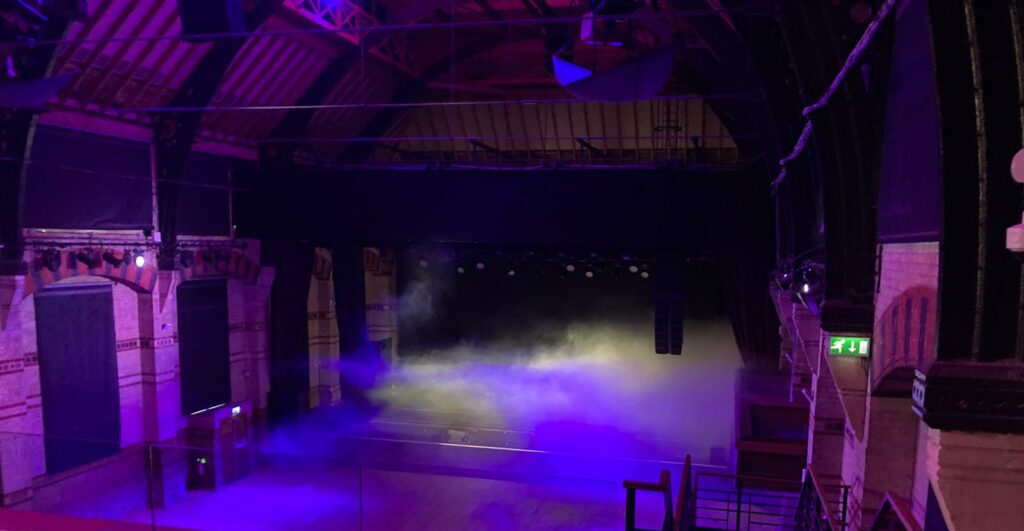 The empty stage at the Corn Exchange, Cambridge, viewed from the stalls.